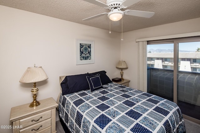 bedroom with a ceiling fan and a textured ceiling