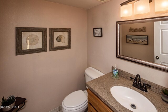 bathroom with toilet and vanity