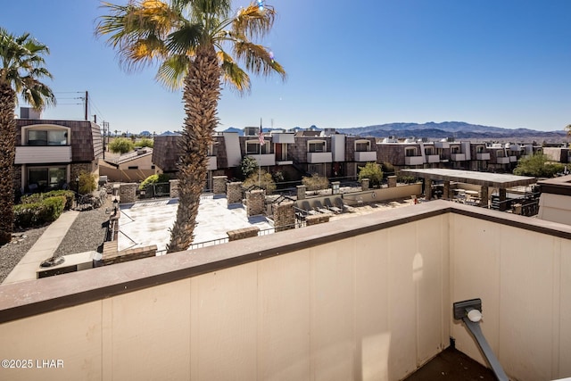 balcony featuring a residential view and a mountain view