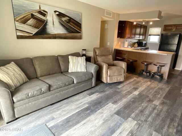 276 Lake Havasu Ave S Unit C19, Lake Havasu City, AZ 86403 - living room with visible vents and dark wood finished floors