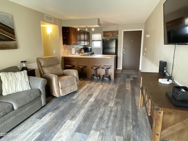 276 Lake Havasu Ave S Unit C19, Lake Havasu City, AZ 86403 - living room with visible vents and dark wood-style flooring
