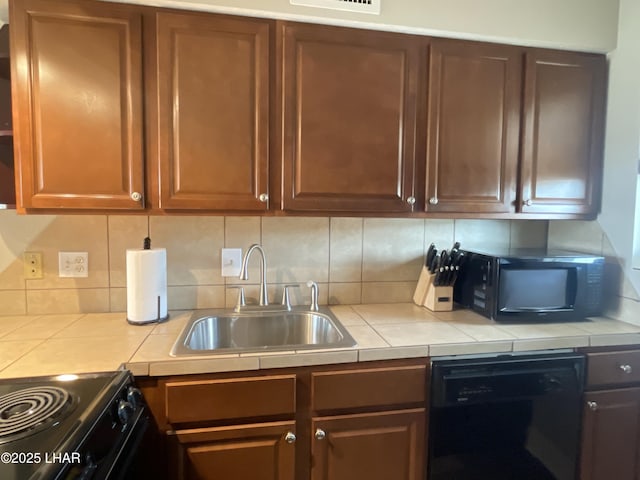 276 Lake Havasu Ave S Unit C19, Lake Havasu City, AZ 86403 - kitchen featuring decorative backsplash, black appliances, tile counters, and a sink