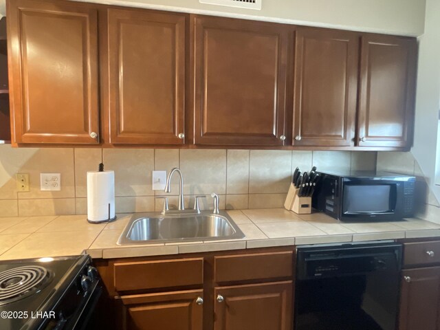 276 Lake Havasu Ave S Unit C19, Lake Havasu City, AZ 86403 - kitchen featuring a sink, tasteful backsplash, black appliances, and tile counters