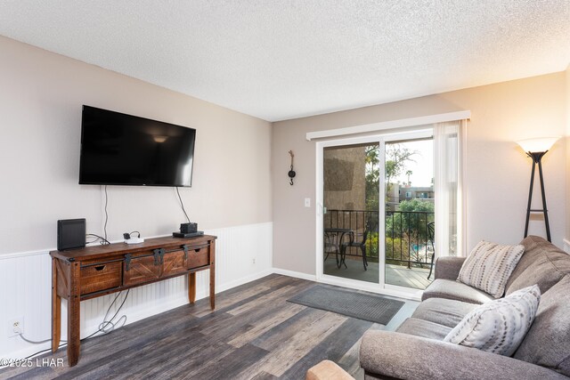 276 Lake Havasu Ave S Unit C19, Lake Havasu City, AZ 86403 - living room with a textured ceiling, dark wood-style flooring, and wainscoting