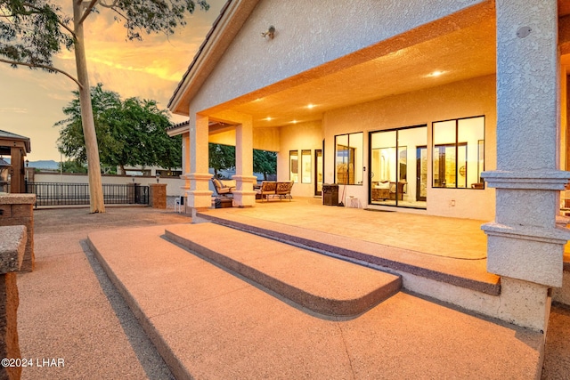 view of patio terrace at dusk