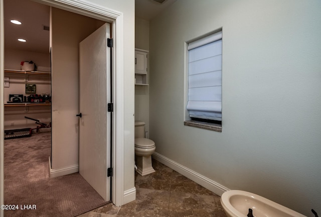 bathroom with a bidet and toilet