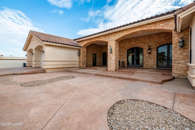 view of front of house featuring a patio and french doors