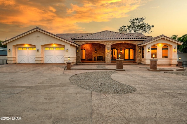 mediterranean / spanish-style home with a garage