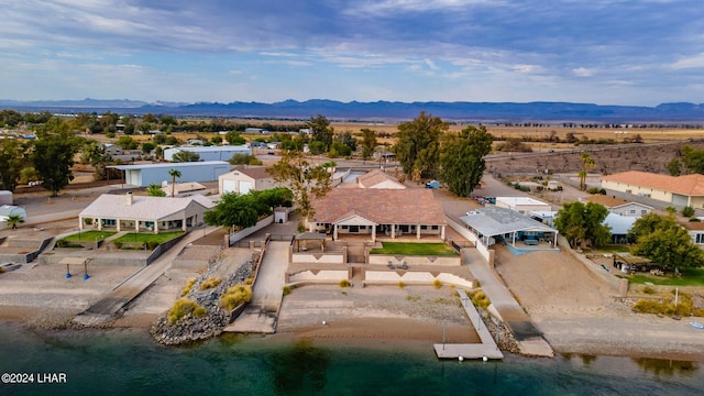 drone / aerial view featuring a water and mountain view