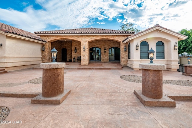 mediterranean / spanish house with a patio area