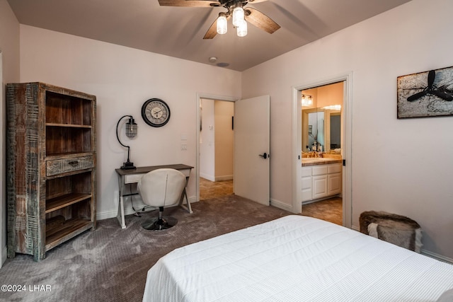 bedroom featuring ensuite bath and dark carpet