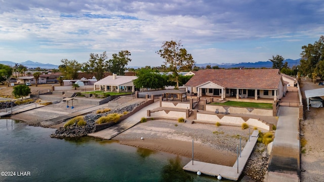 back of property with a water and mountain view