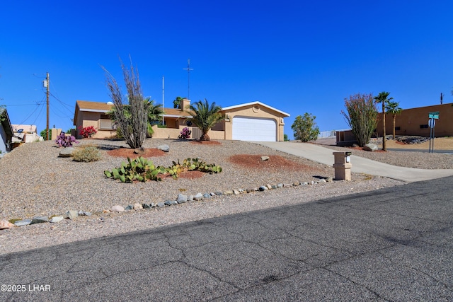 view of front of home with a garage, stucco siding, and concrete driveway