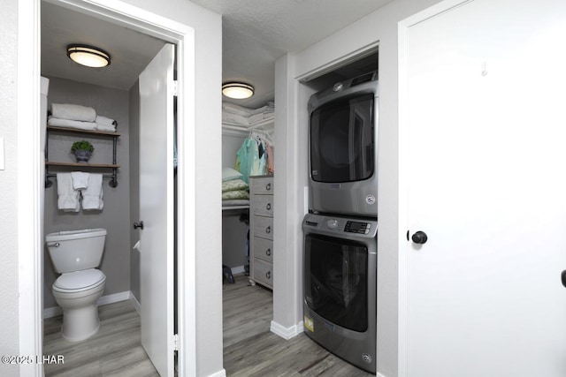 1650 Smoketree Ave S Unit 135, Avenue, Lake Havasu City, AZ 86403 - washroom with stacked washer / dryer, light wood-style floors, and baseboards