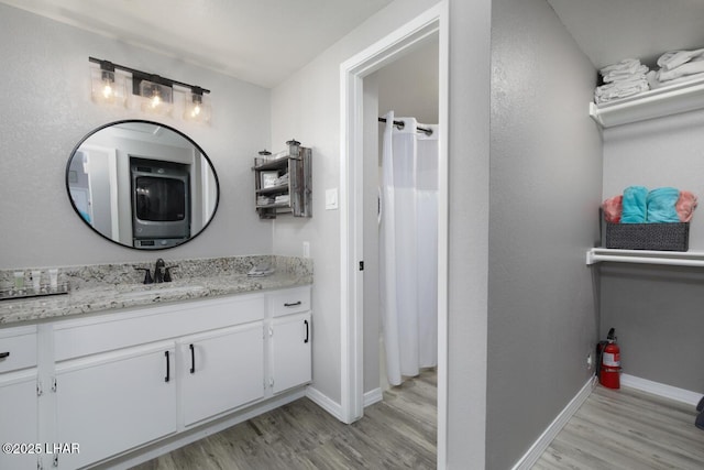 1650 Smoketree Ave S Unit 135, Avenue, Lake Havasu City, AZ 86403 - bathroom with wood finished floors, vanity, baseboards, and washer / clothes dryer