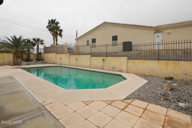 view of pool with a fenced in pool, a patio area, and fence