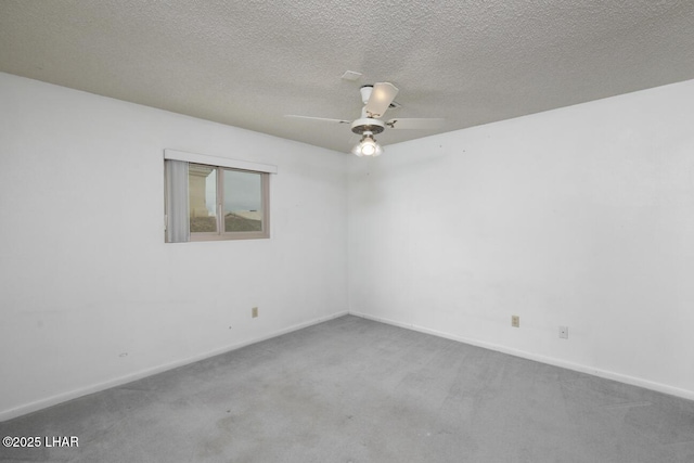 unfurnished room featuring a textured ceiling, carpet flooring, baseboards, and ceiling fan