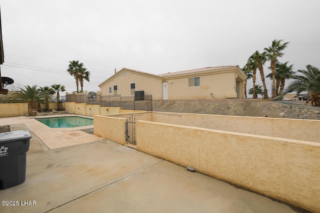 view of swimming pool with a fenced in pool, a patio, and fence