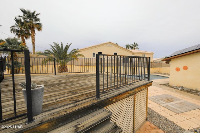 wooden terrace featuring a patio area and fence