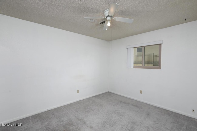 unfurnished room featuring a ceiling fan, carpet, baseboards, and a textured ceiling