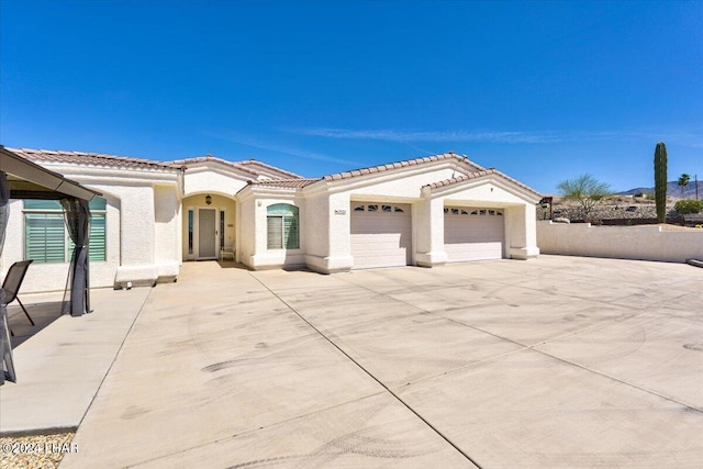 mediterranean / spanish-style home with a garage