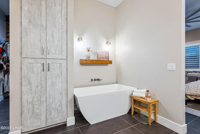 bathroom with tile patterned floors and a washtub