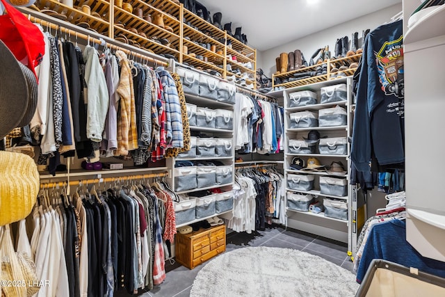 walk in closet featuring dark tile patterned floors