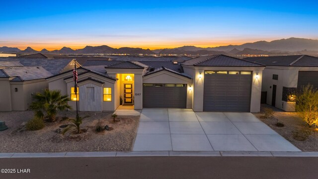 view of front of property featuring a garage and a mountain view