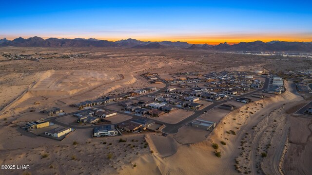 aerial view at dusk featuring a mountain view