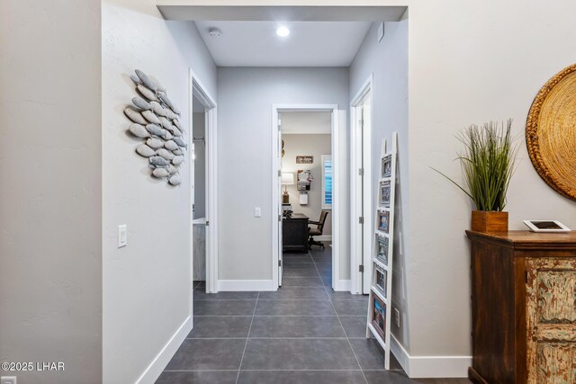 hall featuring dark tile patterned flooring