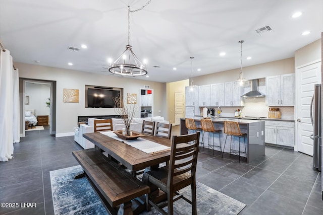 tiled dining area featuring a chandelier