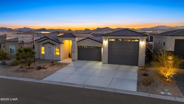 view of front of home with a mountain view and a garage