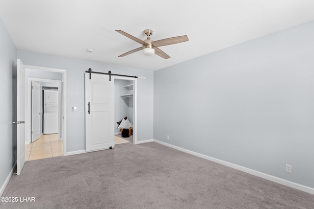 1850 Swanson Ave Unit A16, Lake Havasu City, AZ 86403 - unfurnished bedroom with baseboards, carpet, ceiling fan, and a barn door