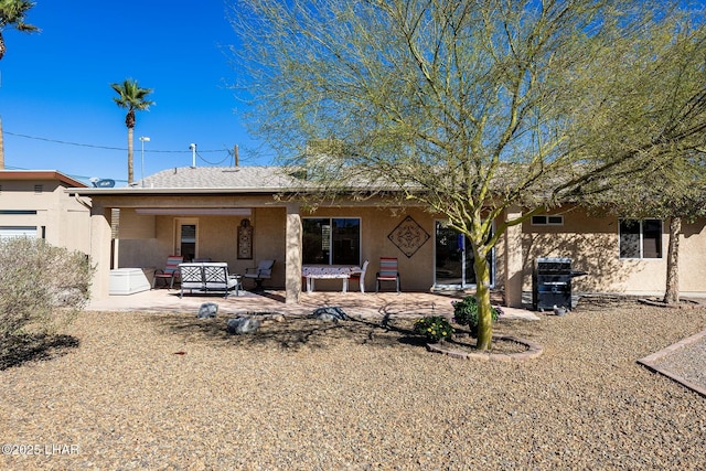 rear view of property featuring a patio area