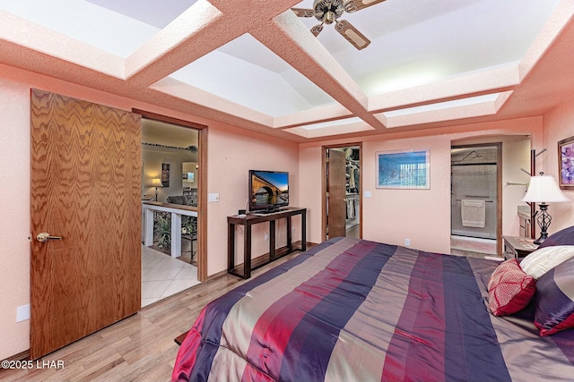 bedroom featuring beamed ceiling, coffered ceiling, and light hardwood / wood-style floors