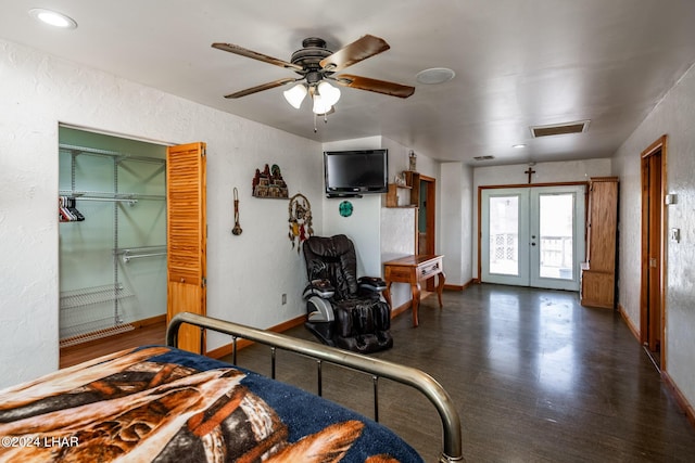 bedroom featuring a closet, dark hardwood / wood-style floors, french doors, and ceiling fan