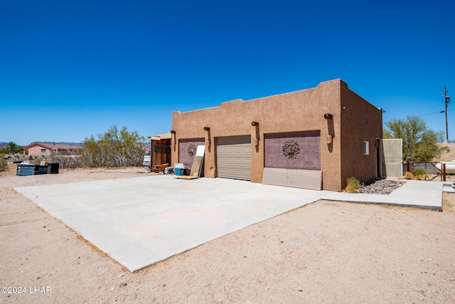 view of side of home featuring a garage