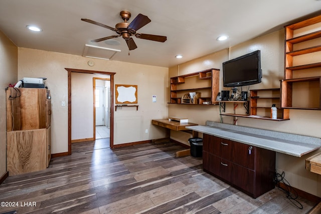 office with ceiling fan, dark hardwood / wood-style flooring, and built in desk