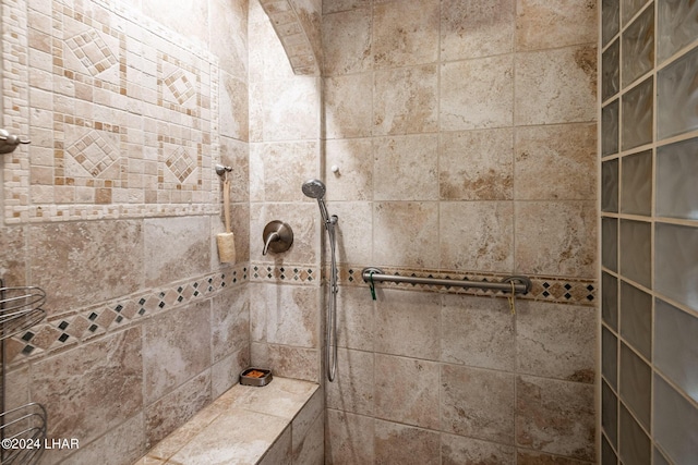 bathroom with a tile shower