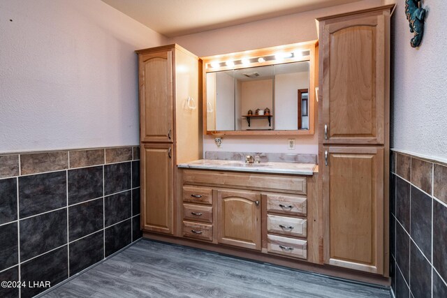 bathroom featuring tile walls, vanity, and hardwood / wood-style flooring