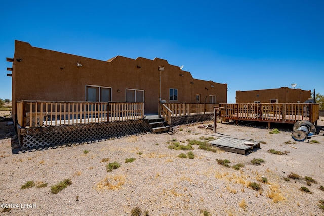 back of house featuring a wooden deck