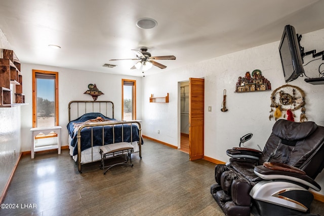 bedroom with multiple windows, ceiling fan, and dark hardwood / wood-style flooring