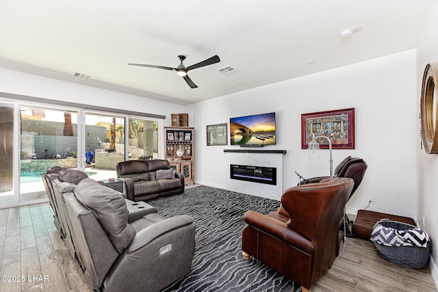 2800 Papeete Dr, Lake Havasu City, AZ 86404 - living room with a high end fireplace, visible vents, a ceiling fan, and wood finished floors