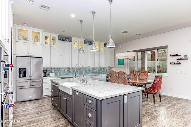 2800 Papeete Dr, Lake Havasu City, AZ 86404 - kitchen with a sink, light wood finished floors, gray cabinetry, high end refrigerator, and decorative backsplash
