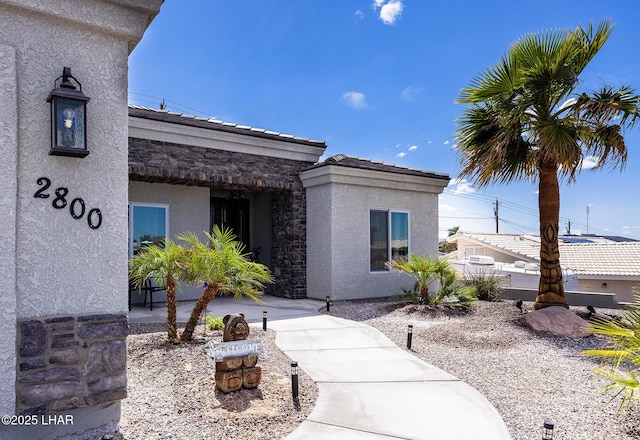 2800 Papeete Dr, Lake Havasu City, AZ 86404 - entrance to property featuring a tiled roof, stone siding, and stucco siding