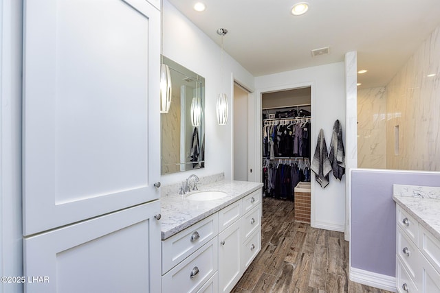 2800 Papeete Dr, Lake Havasu City, AZ 86404 - full bath with vanity, a spacious closet, recessed lighting, visible vents, and wood finished floors