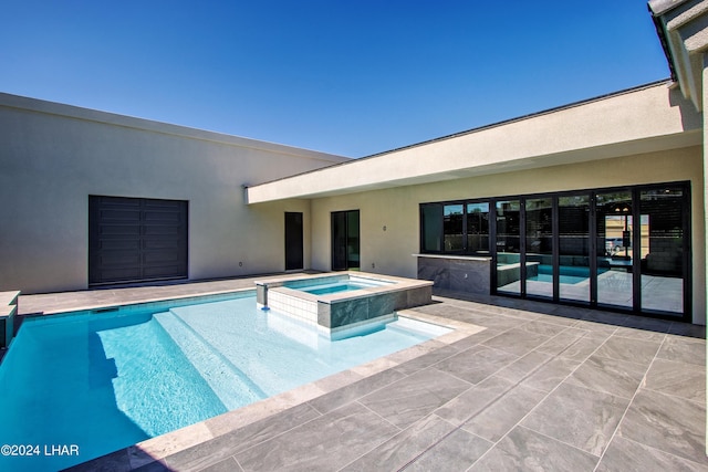 view of pool featuring a pool with connected hot tub and a patio