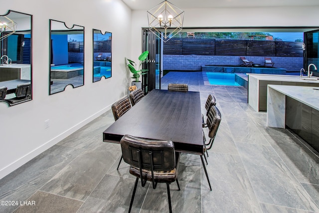 dining room with a chandelier and baseboards
