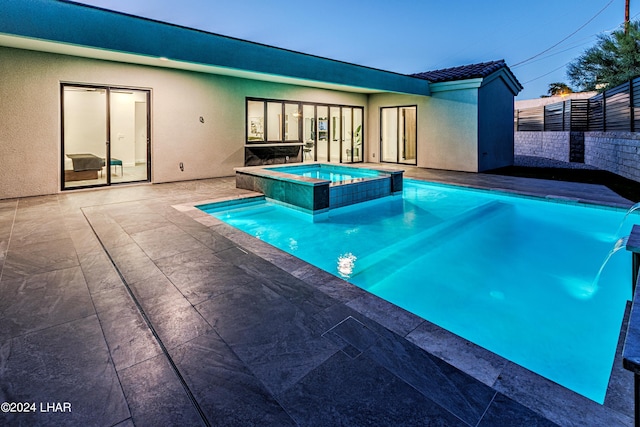 view of pool featuring a patio area, a pool with connected hot tub, and fence