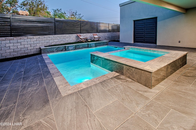 view of pool featuring a pool with connected hot tub, a patio area, and fence